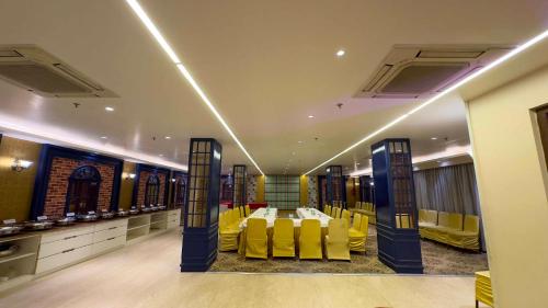 a room with yellow chairs and a table in it at WoodApple Residency in New Delhi