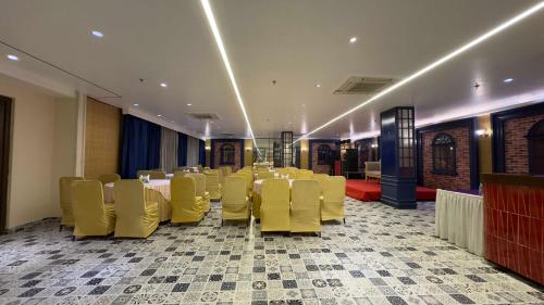 a conference room with yellow chairs and a table at WoodApple Residency in New Delhi