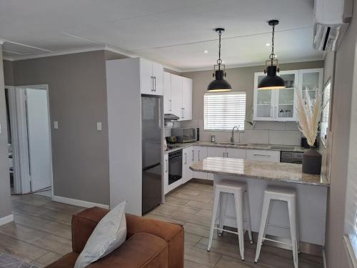 a kitchen with a couch and a table in a room at The Galton Villa in Windhoek