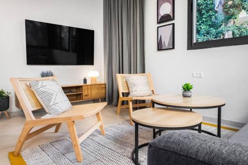 a living room with two chairs and a table at Sweet and rural home in Ra’anana in Ra‘ananna