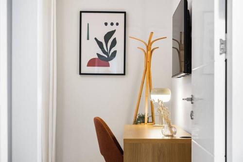 a room with a desk and a picture on the wall at Sweet and rural home in Ra’anana in Ra‘ananna