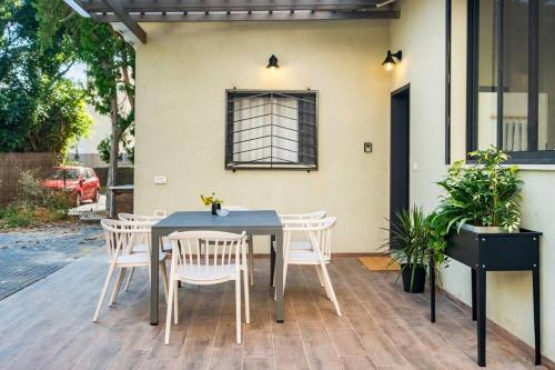 a table and chairs sitting on a patio at Sweet and rural home in Ra’anana in Ra‘ananna