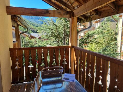 a view from the balcony of a cabin with a table and chairs at AX proche départ rando - piscine - parking gratuit in Ax-les-Thermes