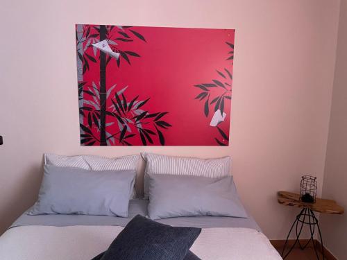 a bedroom with a bed with a painting on the wall at Casa Cuoco in Civita Campomarano