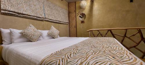 a bedroom with a large bed with pillows on it at Matsya in Havelock Island