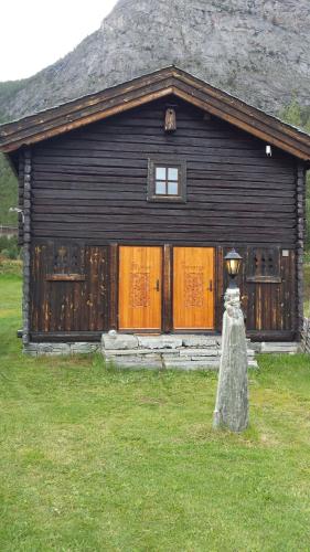 a large wooden house with a light in front of it at Mogard in Skjåk