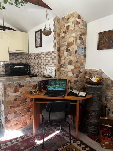 a kitchen with a table with a laptop on it at Studio Apartments KIM - Dilberovic in Mostar