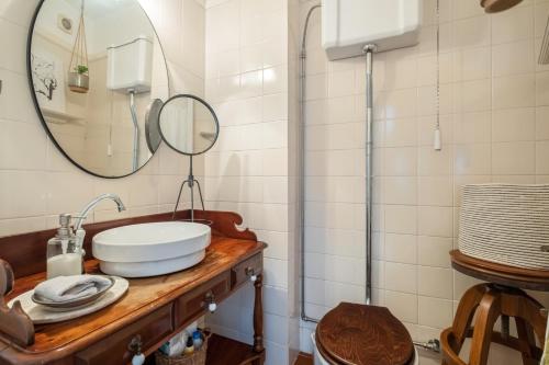a bathroom with a sink and a mirror at Casa Grande da Camélia in São Vicente