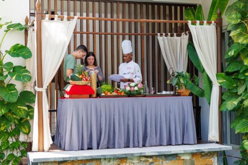 a group of people standing around a table with a chef at SAKABAN Suite in Siem Reap