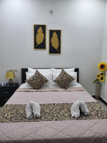 a bedroom with a bed with two towels on it at Hebron Haven in Jaigaon