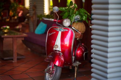 a red scooter parked in a living room at SAKABAN Suite in Siem Reap