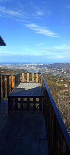 a picnic table sitting on top of a balcony at chemi kera Chalet in Makho