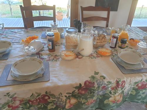 a table with plates of food and bottles of milk at Jilly Park Farmstay Experience Discover Authentic Farm Life Complimentary Breakfast Included in Buln Buln