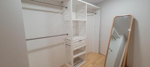 a white closet with a mirror in a room at Moana Luxury Residence in Honolulu