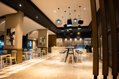 a lobby with stools and tables in a building at Skystay Lucknow in Lucknow