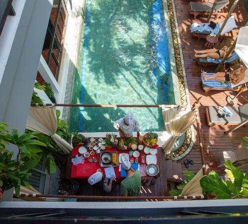 an overhead view of a table in front of a swimming pool at SAKABAN Suite in Siem Reap