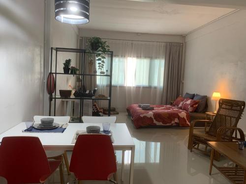 a living room with a table and a couch at COSY 4th floor with rooftop in Bangkok