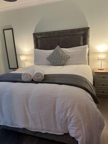 a bedroom with a large white bed with two lamps at Chapel Place, Town Centre in Killarney