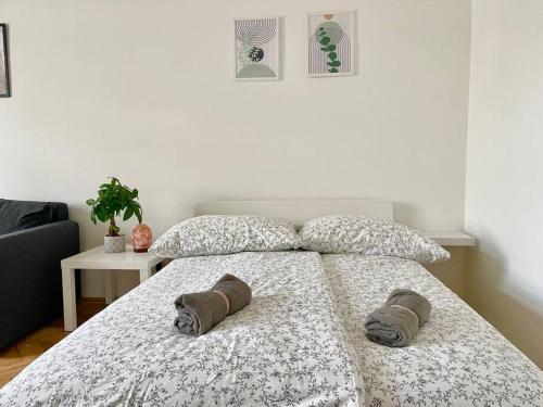 a bedroom with a bed with two pillows on it at 55m2 Stylish Apartment with Netflix - 15 min to Center in Vienna