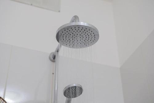 a shower with a shower head in a bathroom at Cocobana Resort two-bedroom apartment ground floor in Willemstad