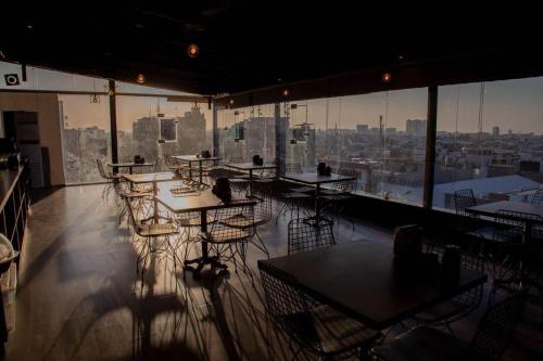 a restaurant with tables and chairs and a view of a city at Nightview Erbil in Erbil