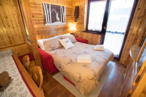 a bedroom with a bed in a wooden cabin at [Cervinia Center] 2 min to SKI + FREE GARAGE in Breuil-Cervinia