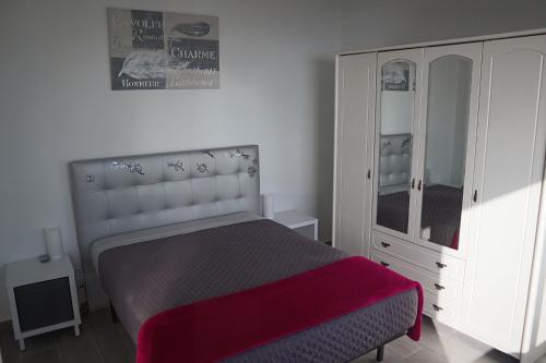 a bedroom with a bed with a dresser and a mirror at Fifty´s House in Ribeira Brava