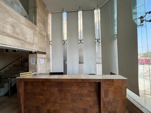 a lobby with a stone counter in a building at Hotel Vinnie in Jaipur