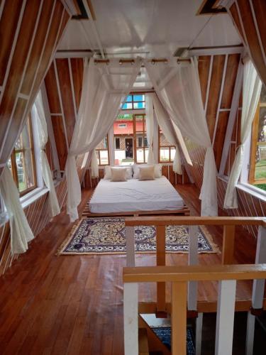 a bedroom with a bed in the middle of a room at Orchard Farmstay in Bijanbāri Bāzār