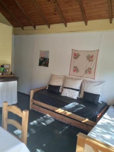 a bedroom with a bed in the corner of a room at Cabañas Nontue in Tigre