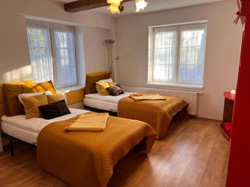 a hotel room with two beds and windows at LedowoHouse in Lędowo
