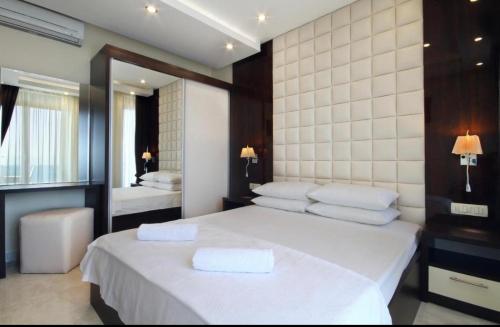 a bedroom with a bed with two towels on it at See View Apartment Budva Becici in Budva