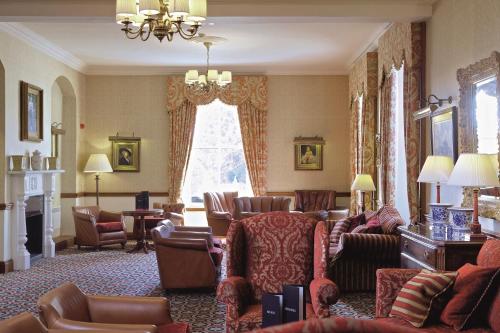 a living room with couches and chairs at Macdonald Crutherland House in East Kilbride
