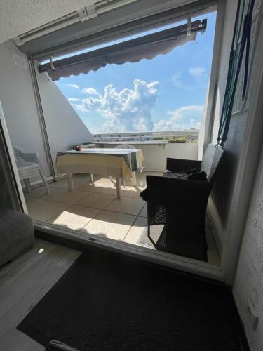 une vue d'un balcon avec une table et des chaises dans l'établissement Naturiste Cap d'Agde Port Ambonne 304, au Cap d'Agde