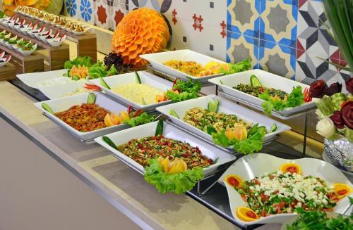 a buffet with many dishes of food on a table at Alaaddin Beach Hotel - Adult Only in Alanya
