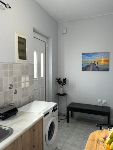 a kitchen with a sink and a washing machine at The Sunlit Retreat in Kremasti