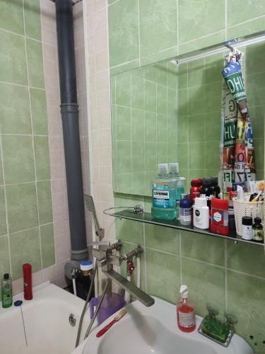 a bathroom with a sink and a mirror and a sink at One room in apartment in the park center area of Chisinau in Chişinău