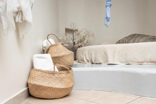 a room with two baskets and a bed at Aggeliki's Diamond in Agia Anna Naxos