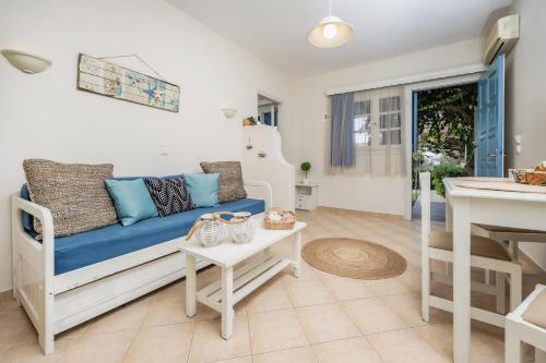 a living room with a couch and a table at Aggeliki's Diamond in Agia Anna Naxos
