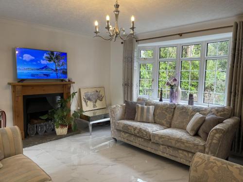 ein Wohnzimmer mit einem Sofa und einem Kamin in der Unterkunft Stunning 4-Bed House in Wetherby near York in Wetherby