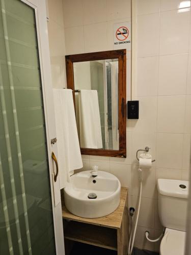 a bathroom with a sink and a mirror and a toilet at Island Luxury Fehendhoo - Friends & Family Hotel in Fehendhoo