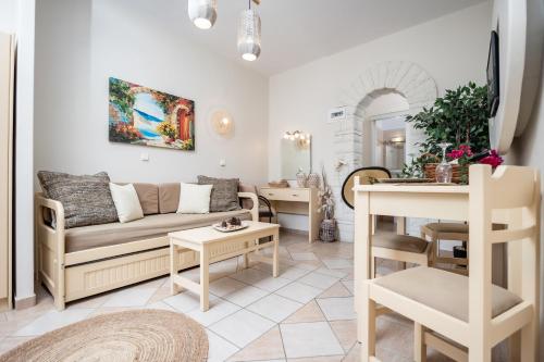a living room with a couch and a table at Aggeliki's Diamond in Agia Anna Naxos