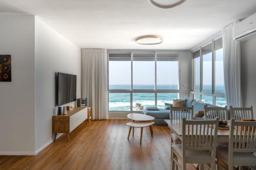a living room with a view of the ocean at O&O Group - Amazing Seaview 3 BR Apartment in Bat Yam