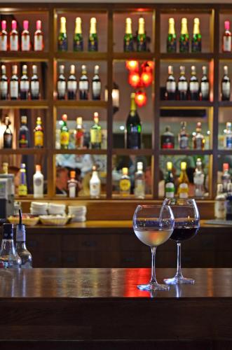 two glasses of wine sitting on a bar at Alaaddin Beach Hotel - Adult Only in Alanya
