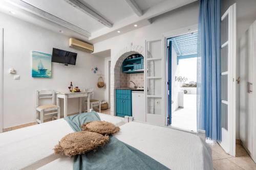 a bedroom with a bed and a kitchen at Aggeliki's Diamond in Agia Anna Naxos