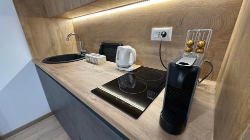 a small kitchen with a counter with a sink at South Apartmani in Vranje