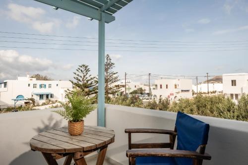 a table and two chairs on a balcony with a view at Aggeliki's Diamond in Agia Anna Naxos