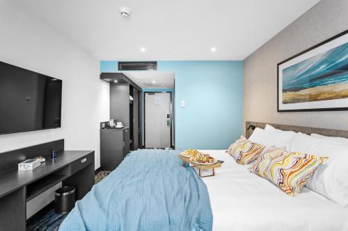 a hotel room with a bed and a flat screen tv at ibis Styles Paignton in Paignton