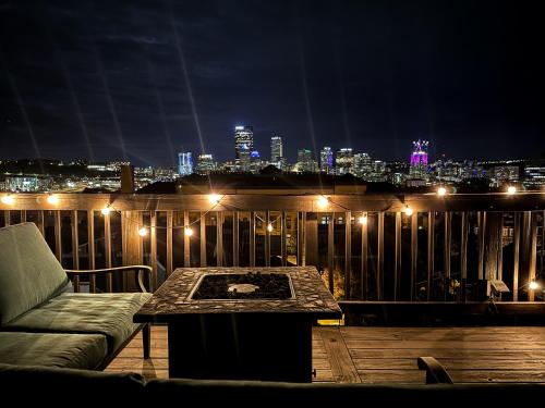 a balcony with a couch and a table at night at Steel City Getaway w/City View in Pittsburgh