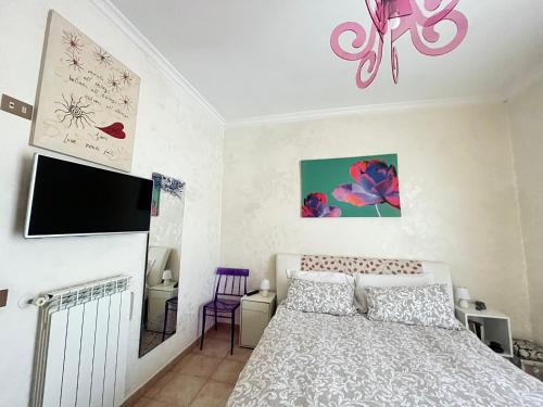 a bedroom with a bed and a flat screen tv at A.B Battistini Short Let's in Rome